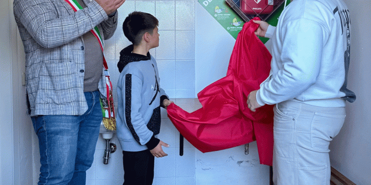 Il momento emozionante in cui i figli di Filippo, Gabriele e Tommaso, procedono insieme al sindaco allo scoprimento del defibrillatore.